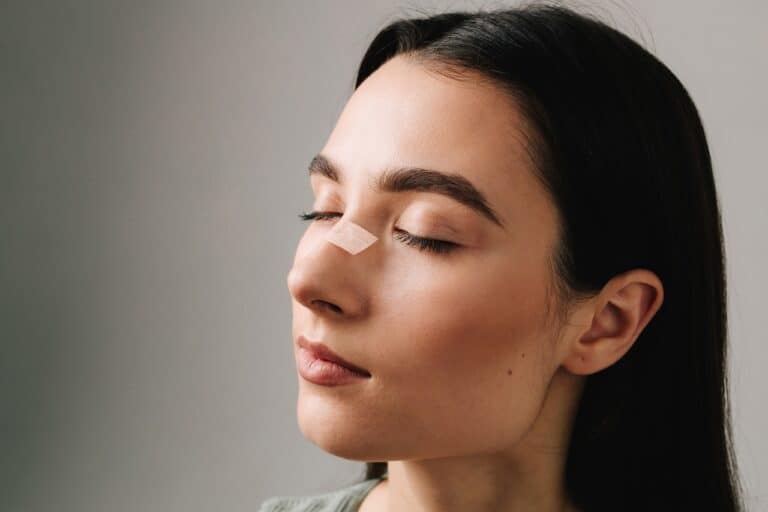 woman with bandage on nose close up